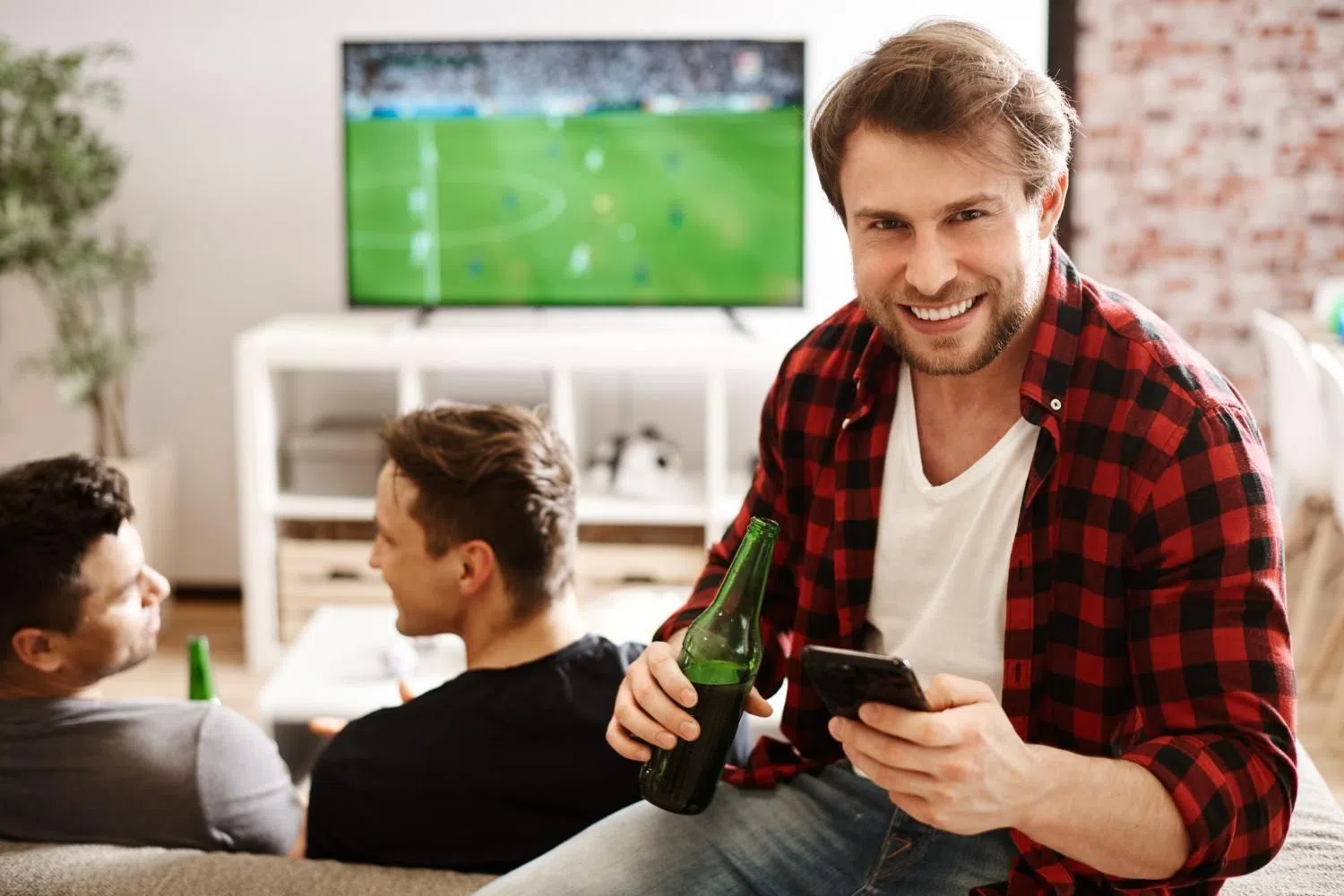 Football fan using mobile phone for match analysis